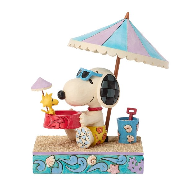 Snoopy tenant Woodstock dans un bol à la plage - Peanuts